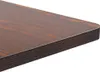A close-up view of the corner of a dark brown wooden table. Podgląd zdjęcia produktu