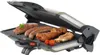 A close-up shot of an open electric grill with various meats and vegetables cooking on it. Produktbild-Vorschau