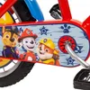 A close-up view of a children's bicycle with Paw Patrol characters on the chain guard. Podgląd zdjęcia produktu