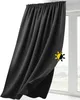 A black curtain hanging in front of a window. Produktbild-Vorschau