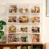 A display of multiple miniature dollhouse-like shops in clear display cases, arranged on shelves. Podgląd zdjęcia produktu