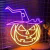 A neon sign of a jack-o'-lantern wearing a witch's hat, displayed indoors. Produktbild-Vorschau