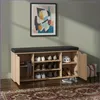 A shoe cabinet with a bench seat in a room with a rug and a framed picture on the wall. Náhľad obrázku produktu