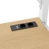 A close-up view of a black power strip with two USB ports and two circular openings, embedded into a light brown wooden surface. Produktbild-Vorschau