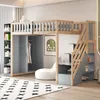 A child's loft bed with integrated storage and a wardrobe, set up in a bedroom. Voir les images du produit