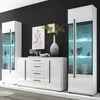 A modern living room display featuring a white high-gloss sideboard and two glass-fronted display cabinets with blue LED lighting. Produktbild-Vorschau