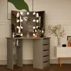 A vanity table with a tri-fold mirror and LED lights, displaying various makeup and skincare products. Voir les images du produit