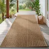 A rug is placed on a wooden deck outdoors, with plants and a basket in the background. Podgląd zdjęcia produktu
