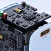 A close-up, exploded view of the internal components of a white USB-C charger, revealing its circuit board and electronic parts. Anteprima dell’immagine prodotto
