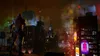 A character stands on a rooftop overlooking a city at night. Podgląd zdjęcia produktu