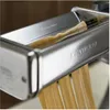 A close-up shot of a Kenwood pasta maker attachment cutting fettuccine noodles. Produktbild-Vorschau