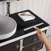 A person is cleaning a bathroom countertop with a squeegee. Podgląd zdjęcia produktu