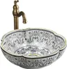 A decorative ceramic sink with a faucet. Anteprima dell’immagine prodotto