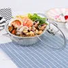 A pot of seafood and vegetables is displayed on a blue and white checkered cloth. Produktbild-Vorschau
