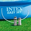 An Intex Easy Set pool with two filtration units connected by hoses, set up on a grassy lawn. Anteprima dell’immagine prodotto