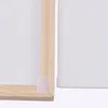 Close-up view of the corner of a wooden frame and a white surface with a velcro strip. Produktbild-Vorschau
