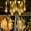 A collage of images showing solar-powered string lights with teardrop-shaped LED bulbs. Produktbild-Vorschau