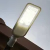 A street lamp is mounted on a brown structure against a light gray sky. Náhľad obrázku produktu