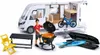 A toy camper van set with accessories, including a figure, grill, table, chair, bicycle, and surfboards. Voir les images du produit