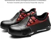 A pair of black and red safety shoes are displayed on a white background. Produktbild-Vorschau