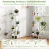 Two white metal plant stands filled with various plants and decorative items, set against a light gray and white background with a window in the background. Produktbild-Vorschau