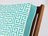 A close-up of a pillow with a geometric pattern on a wooden chair. Produktbild-Vorschau
