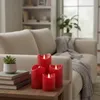 A living room scene with a couch, a table, and decorative candles. Produktbild-Vorschau