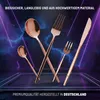 A collection of rose gold cutlery arranged artistically on a dark, reflective surface with purple and blue neon light effects in the background. Produktbild-Vorschau