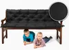 Two young children are lying on the floor under a wooden bench with a black cushion. Produktbild-Vorschau