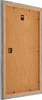 The back of a picture frame is shown, with the frame itself in a grey, weathered finish and the backing board in a natural wood color. There are two small black clips visible on the backing board, likely for securing the picture. Produktbild-Vorschau