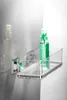 A clear acrylic shelf with chrome accents mounted on a wall, holding two spray bottles. Produktbild-Vorschau
