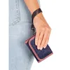 A person's hand holding a wallet with a wrist strap attached to their wrist. Náhled obrázku produktu