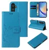 A collage of images showing a blue floral and butterfly patterned flip phone case from different angles. Produktbild-Vorschau