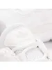 A close-up view of the front of a white Adidas sneaker, focusing on the tongue and laces. Podgląd zdjęcia produktu