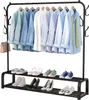A black metal garment rack with clothes hanging on it and shoes on the shelves below. Voir les images du produit