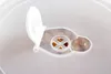 A close-up view of a white and transparent plastic container lid with an open flap and a central vent. Produktbild-Vorschau