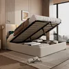 A bed with its storage compartment open, revealing stored items, in a bedroom setting. Náhled obrázku produktu