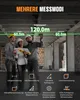 Three construction workers are standing in a building under construction, looking at a laser measuring device. Podgląd zdjęcia produktu