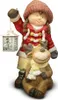 A ceramic figurine of a girl holding a lantern and standing next to a reindeer. Produktbild-Vorschau