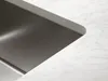 A close-up view of a stainless steel sink integrated into a marble countertop. Produktbild-Vorschau