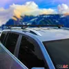 A car with roof racks installed, set against a blurred mountainous landscape. Produktbild-Vorschau