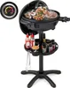 A black electric grill with food cooking on it, a thermometer, and a tray with condiments and spices. Náhled obrázku produktu