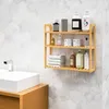 A bamboo shelf with various bath products and towels in a bathroom. Produktbild-Vorschau