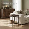A living room scene featuring a wooden sideboard, a white sofa with cushions, and a small side table with a basket and candles. Produktbild-Vorschau