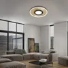 A modern living room with a large sectional sofa, coffee table, and artwork, featuring a ceiling light. Produktbild-Vorschau