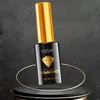 A bottle of nail polish is displayed on a pedestal with decorative rings. Produktbild-Vorschau