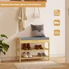 A bamboo shoe rack with a cushioned seat is shown in an entryway setting, with shoes on the shelves and coats hung on the wall above. The image has text overlays and icons. Produktbild-Vorschau