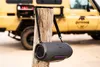 A portable speaker is hanging from a wooden post in front of a yellow off-road vehicle. Produktbild-Vorschau
