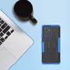 A smartphone case is shown next to a laptop and a mug of coffee on a light blue background. Produktbild-Vorschau