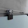 A close-up view of a sliding glass door track and roller system mounted on a concrete wall. Produktbild-Vorschau